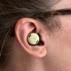 The Google Pixel Buds Pro being worn in a woman's ear.